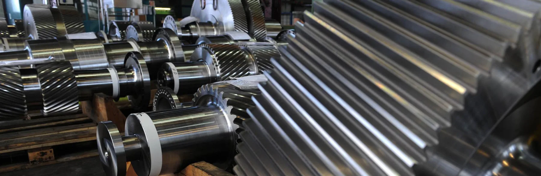 A row of freshly machined pinion and gear shafts at Gear Force Machine.