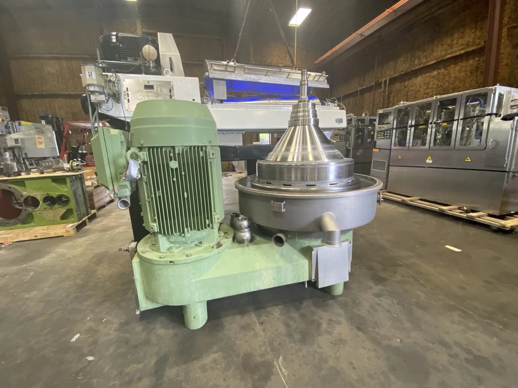 A green GEA disc-stack separator centrifuge with the bowl cone visible at Gear Force Machine.
