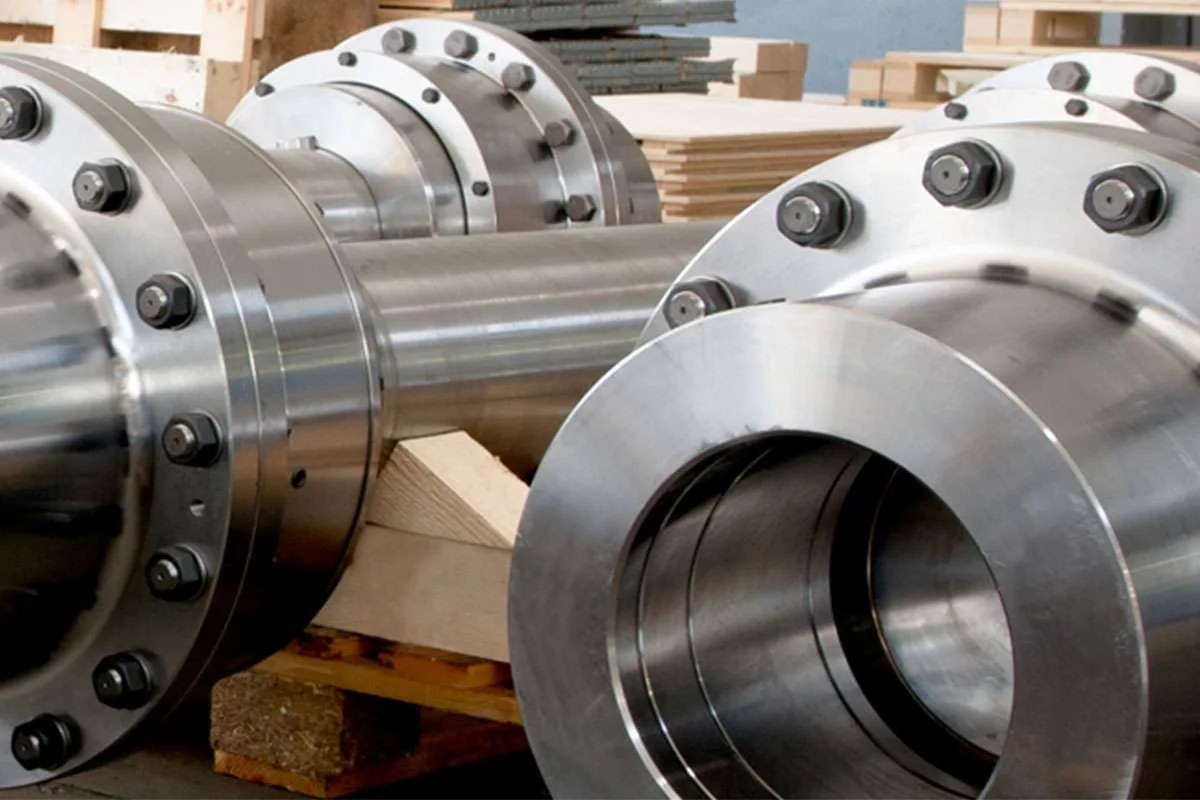 Machined flanged gear couplings and spindle shafts on a pallet at Gear Force Machine.