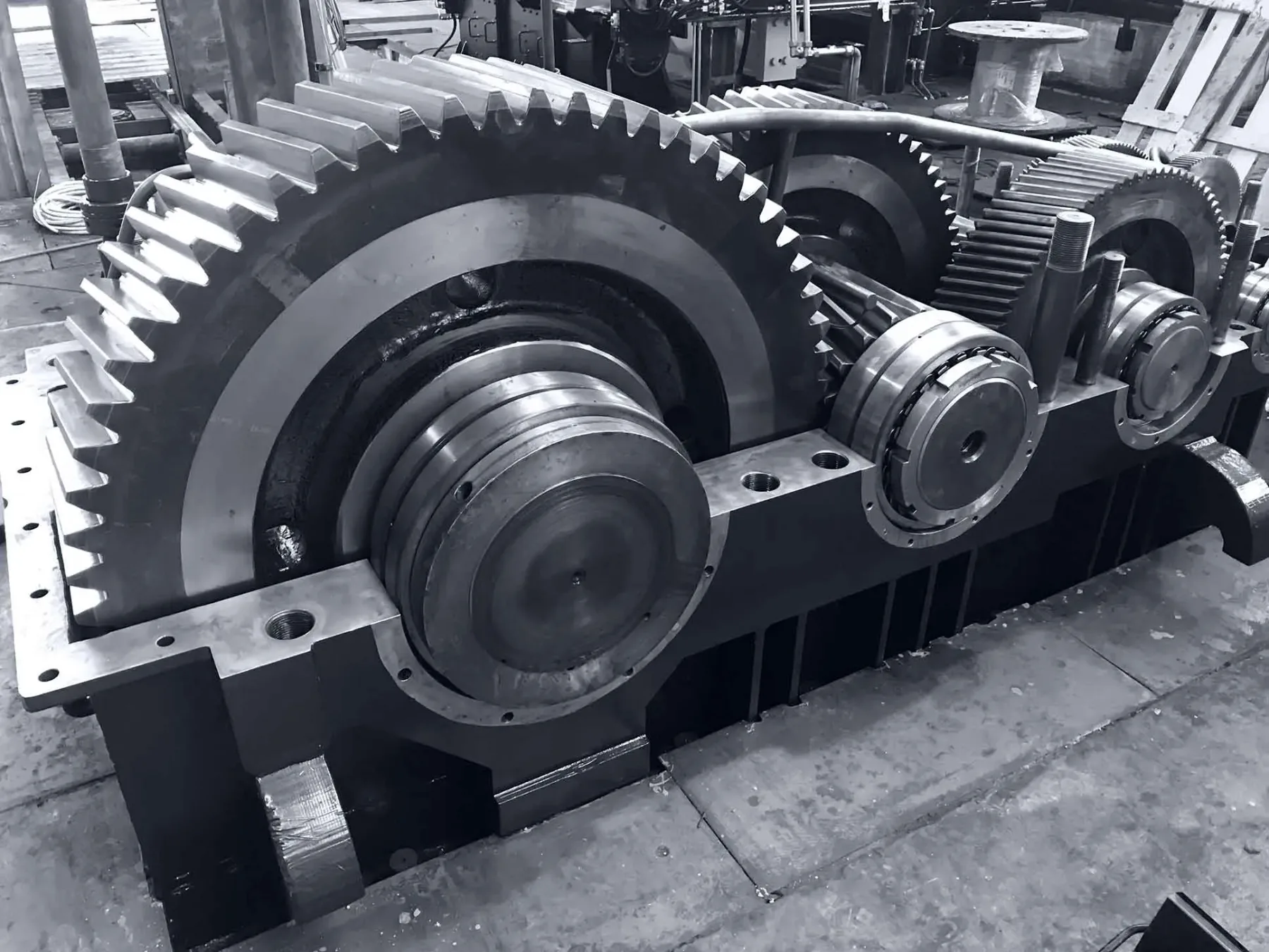 An open industrial gearbox housing with the full reduction gear train exposed during rebuild at Gear Force Machine.