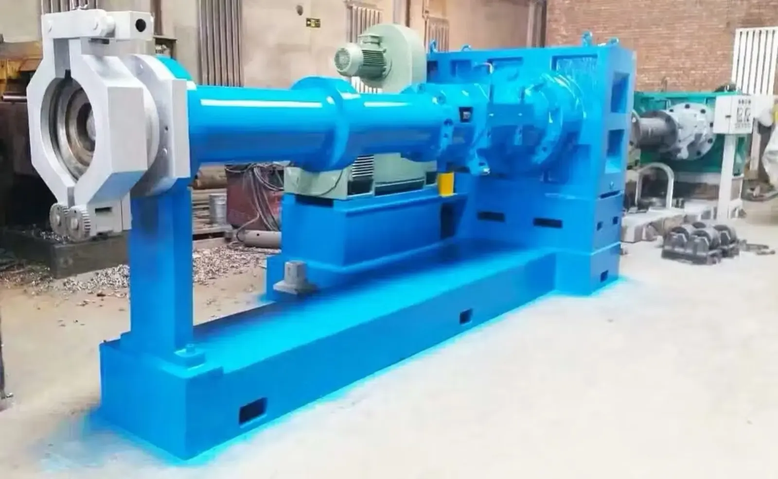 A blue industrial extruder rebuilt at Gear Force Machine, staged in the shop after final paint and reassembly.