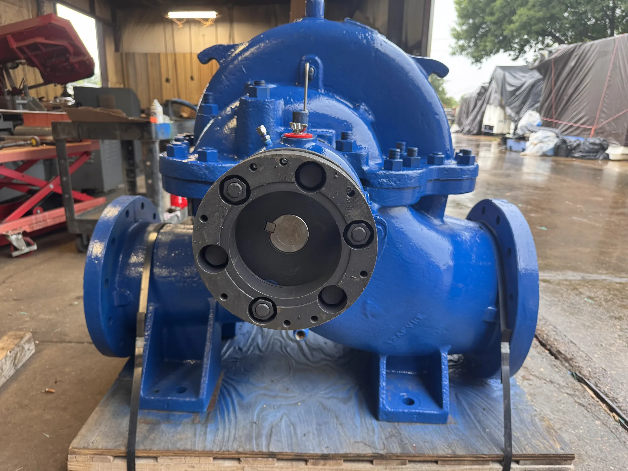 A freshly rebuilt blue split-case centrifugal pump in the Gear Force Machine shop, painted and reassembled with the coupling end facing the camera.