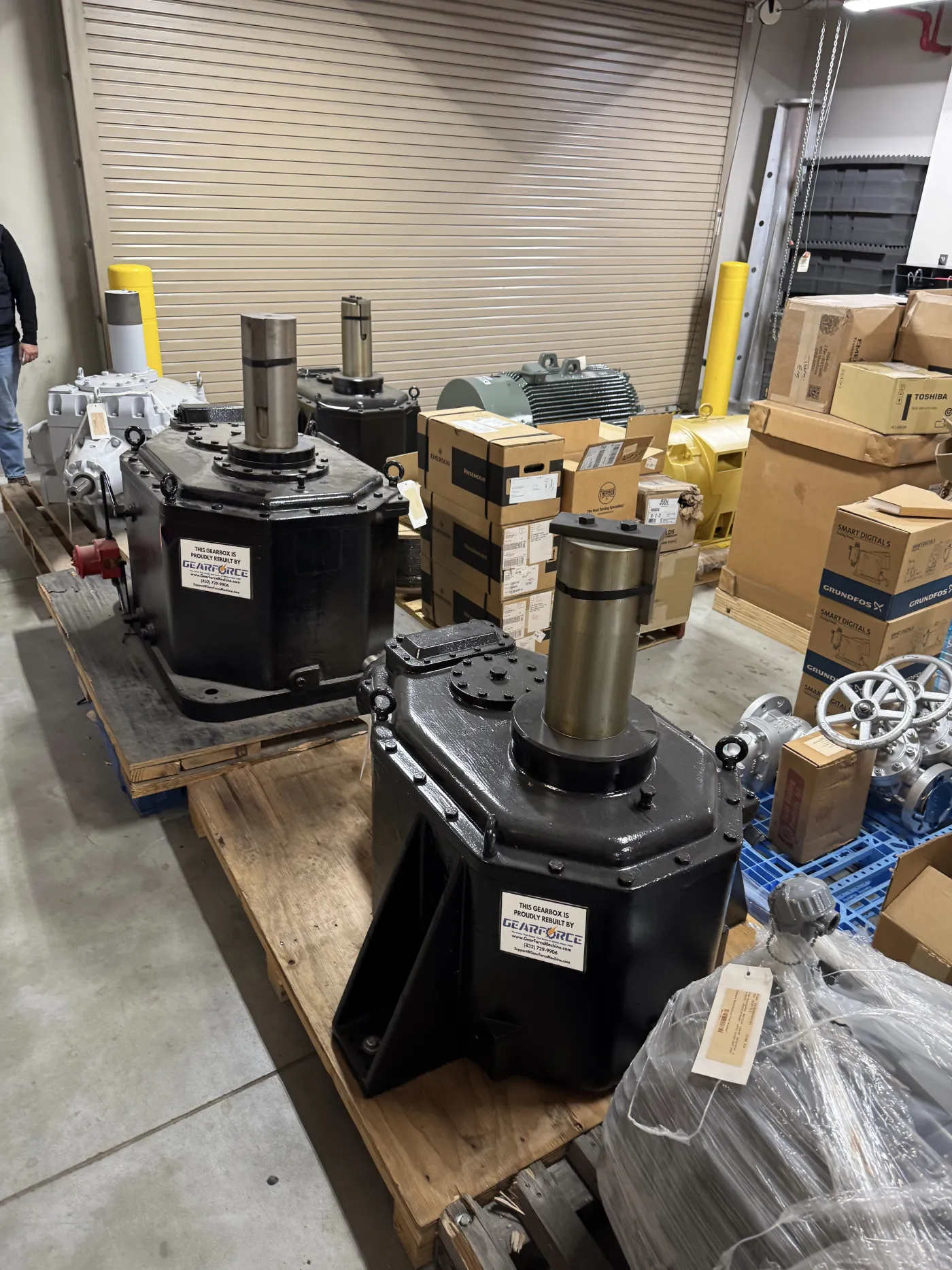 Rebuilt gearboxes with Gear Force rebuild tags staged in the shop, ready for a steel or metals plant.